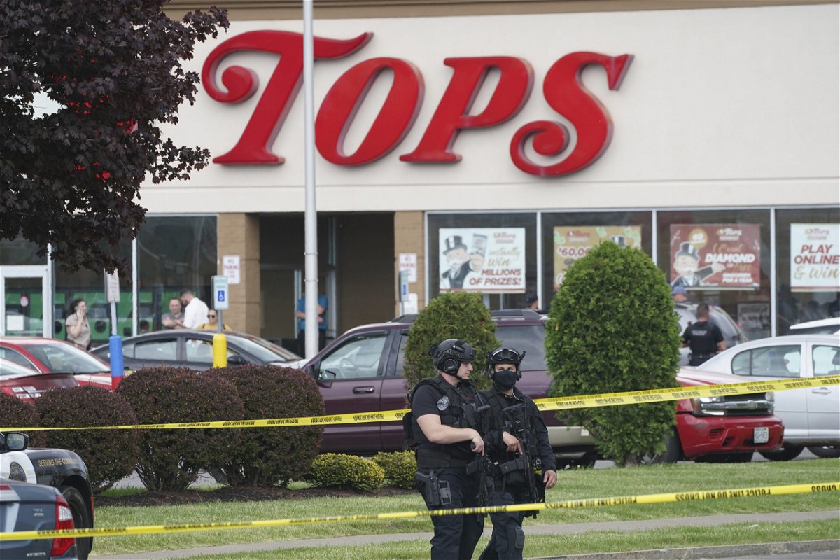 <i>Derek Gee/The Buffalo News/AP</i><br/>Police secure an area around a supermarket where several people were killed in a shooting