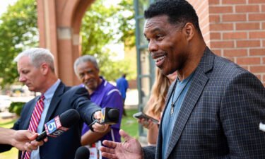 Republican Senate candidate Herschel Walker speaks with reporters after a campaign rally at the Georgia Sports Hall of Fame in Macon on May 18.
