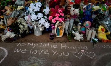 Messages were written in chalk on a sidewalk next to a memorial at Robb Elementary School in Uvalde