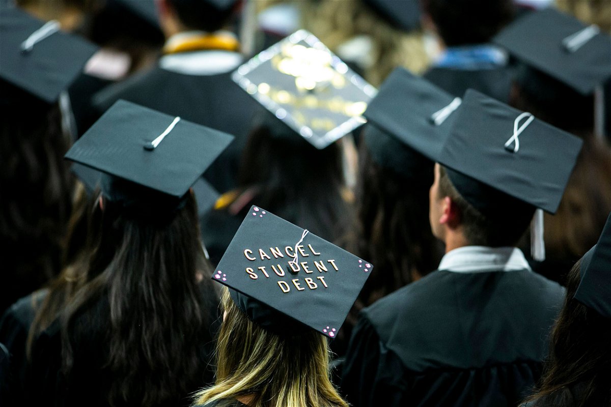 <i>Joseph Cress/Iowa City Press-Citizen/AP</i><br/>The cap of a University of Iowa graduates candidate is decorated with writing reading 