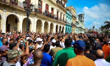 Cuban President Miguel Diaz-Canel (C) is seen during a demonstration held by citizens to demand improvements in the country