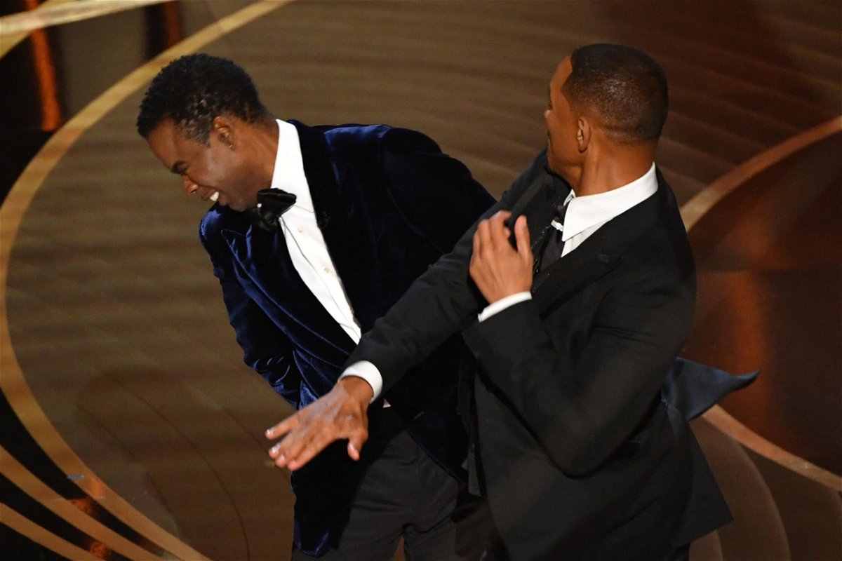 Will Smith and Chris Rock onstage during the Academy Awards in March. Smith posted a video to his verified Instagram account saying he's "deeply remorseful" about slapping Rock.
