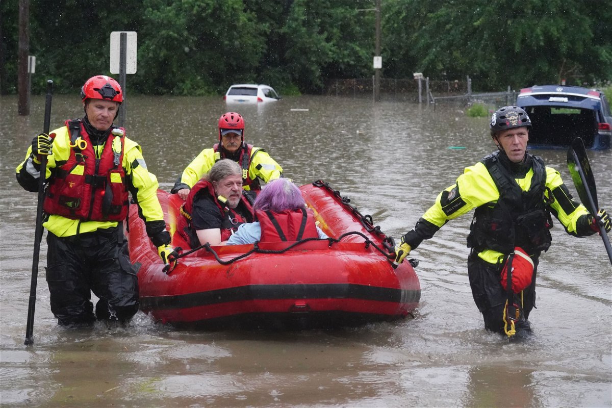 <i>Bill Greenblatt/UPI/Shutterstock</i><br/>St. Louis firefighters seen bringing homeowners to dry land following flooding on Tuesday