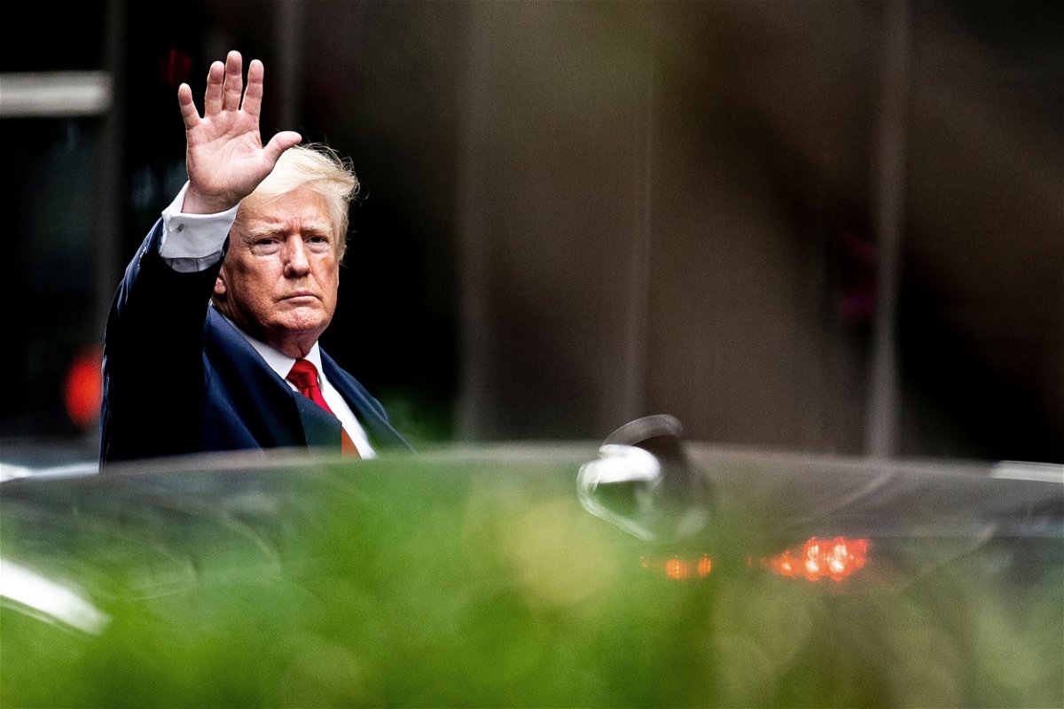 <i>Julia Nikhinson/AP</i><br/>Former President Donald Trump waves as he departs Trump Tower on August 10 in New York City. A federal appeals court ruled that the DOJ must make a public memo analyzing whether to charge Trump in the Russia investigation.