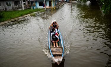 Students ride a boat to school during the first day of in-person classes in Macabebe