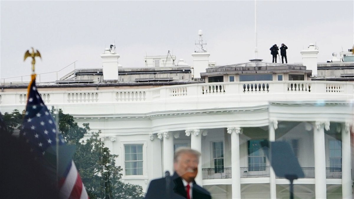 <i>MANDEL NGAN/AFP via Getty Images</i><br/>Members of the Secret Service patrol from the roof of the White House on January 6