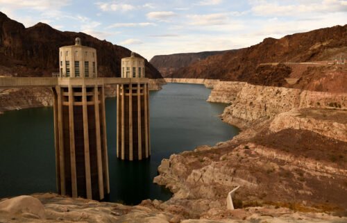 Intake towers for water to enter to generate electricity and provide hydroelectric power stand during low water levels due the western drought in July of 2021 at the Hoover Dam.