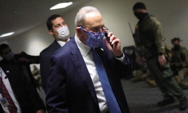Then Senate Minority Leader Chuck Schumer walks to a room on Capitol Hill where senators gathered on January 6