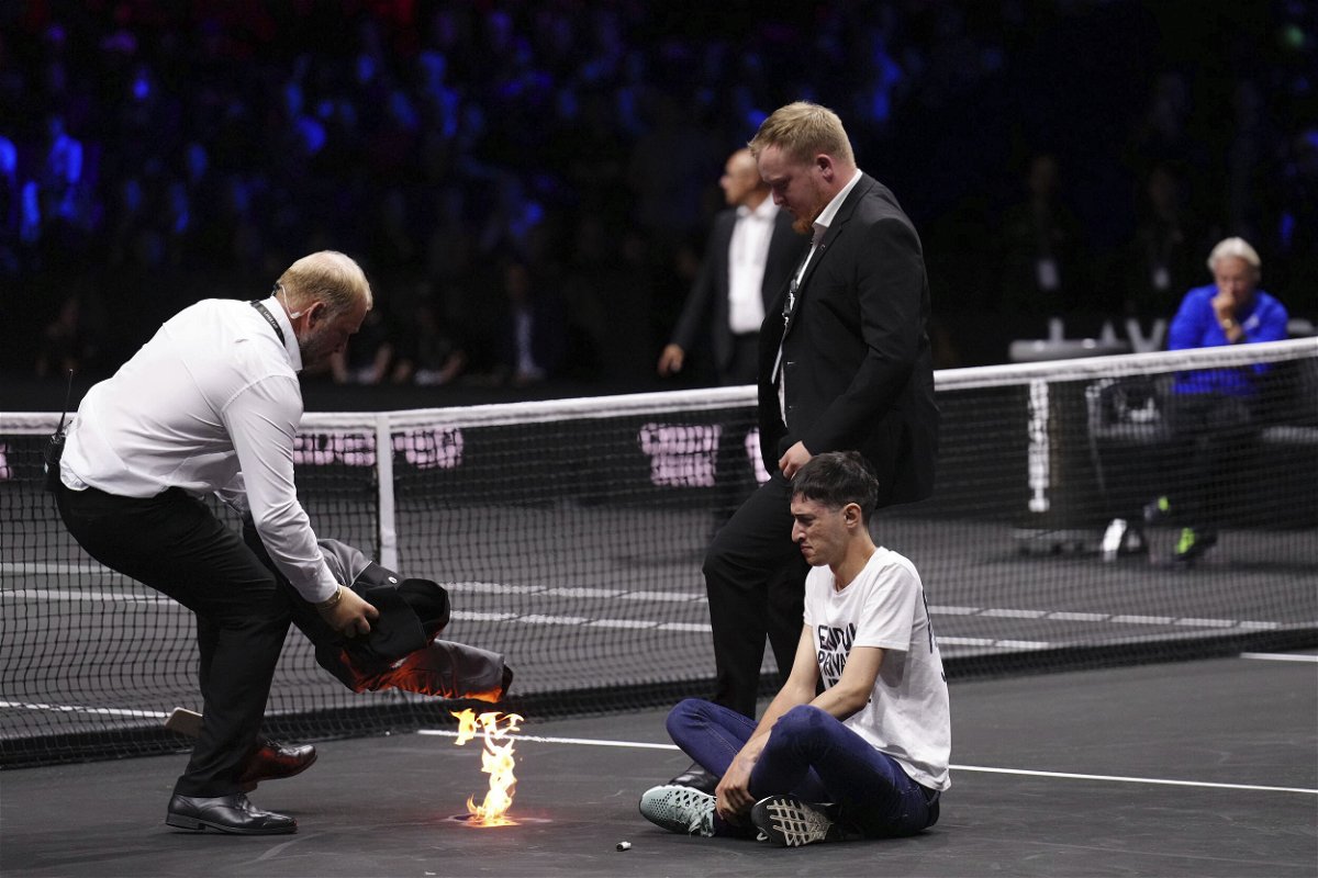 <i>John Walton/PA/AP</i><br/>A protester lit a fire on the court at the Laver Cup at the O2 Arena in London on September 23.