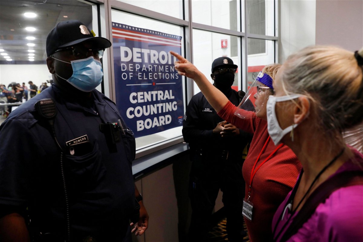 <i>Jeff Kowalsky/AFP/Getty Images</i><br/>Police officers are seen outside the room where absentee ballots for the 2020 general election were counted on November 4