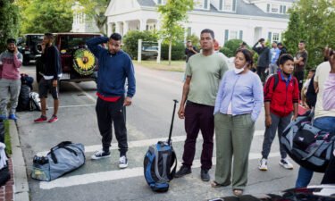 Biden administration officials are set to meet on September 16 to discuss a multitude of critical immigration issues. Immigrants are pictured here gathering with their belongings outside St. Andrews Episcopal Church
