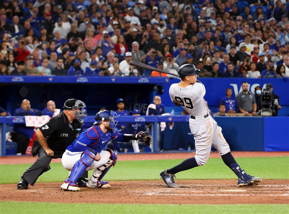 <i>Vaughn Ridley/Getty Images</i><br/>Wife of Toronto Blue Jays coach jokes about 'divorce' after watching her husband give away Aaron Judge's lucrative home run ball. Judge is pictured here hitting his 61st home run of the season.