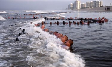 Navy SEAL candidates participate in "surf immersion" during Basic Underwater Demolition/SEAL (BUD/S) training at the Naval Special Warfare (NSW) Center in Coronado