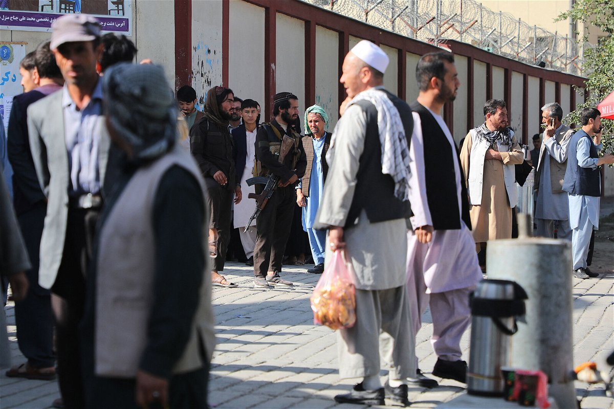 <i>AFP/Getty Images</i><br/>Taliban fighters stand guard as people search for relatives outside a hospital in Kabul on September 30