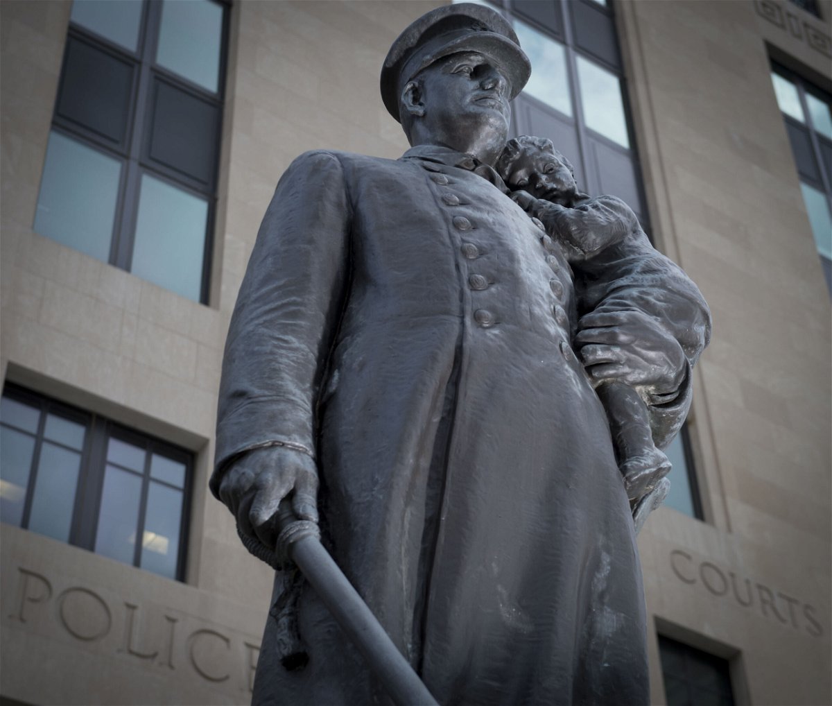 <i>Shane Keyser/Kansas City Star/Tribune News Service/Getty Images</i><br/>The US Department of Justice is investigating whether the Kansas City Police Department in Missouri engaged in a pattern of racial discrimination against Black officers. A statue of a police officer holding a child is pictured here.