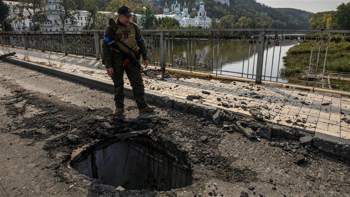 <i>Vladyslav Musiienko/Reuters</i><br/>A member of Ukraine's National Guard stands at a bridge over the Siverskyi Donets river in the Donetsk region on October 1.