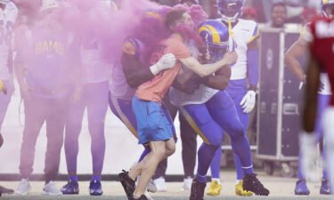 A protester is hit by Los Angeles Rams defensive end Takkarist McKinley
