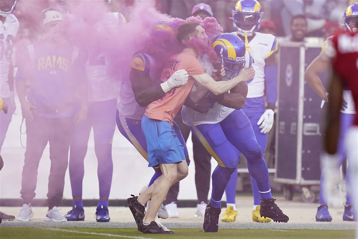 <i>Godofredo A. Vásquez/AP</i><br/>A protester is hit by Los Angeles Rams defensive end Takkarist McKinley