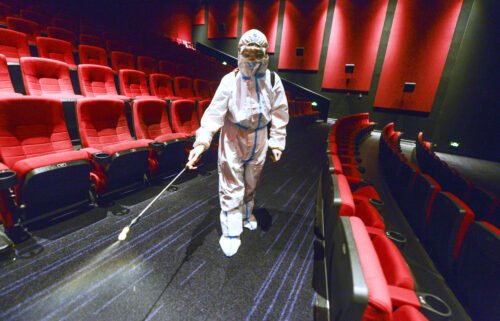 China has banned residents from leaving Xinjiang over a Covid-19 outbreak. A worker is seen here wearing personal protective equipment disinfecting a cinema on August 9 in Urumqi