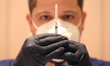 Jatniel Hernandez fills syringes with COID-19 vaccine booster shots on April 6 in San Rafael