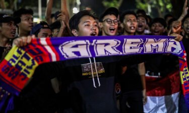 Soccer fans chant slogans during a candle light vigil for Arema FC Supporters who became victims of Saturday's soccer riots