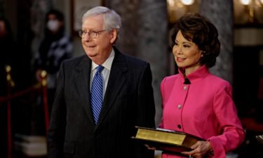 Then-Senate Majority Leader Mitch McConnell waits to be sworn-in with his wife Elaine Chao