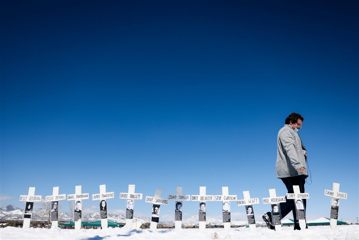 <i>Michael Ciaglo/Getty Images</i><br/>Tyler Vielie walks past crosses with the names of the victims of the Columbine High School shooting next to the Columbine Memorial on April 20