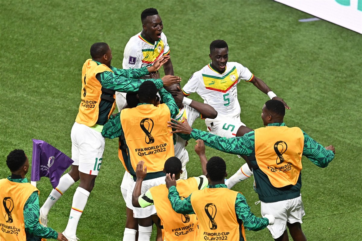 <i>Ozan Kose/AFP via Getty Images</i><br/>Ismaila Sarr (right) celebrates scoring Senegal's first goal at the Khalifa International Stadium on Tuesday.