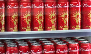 Cans of Budweiser beer featuring the FIFA World Cup logo are displayed in Doha on November 18