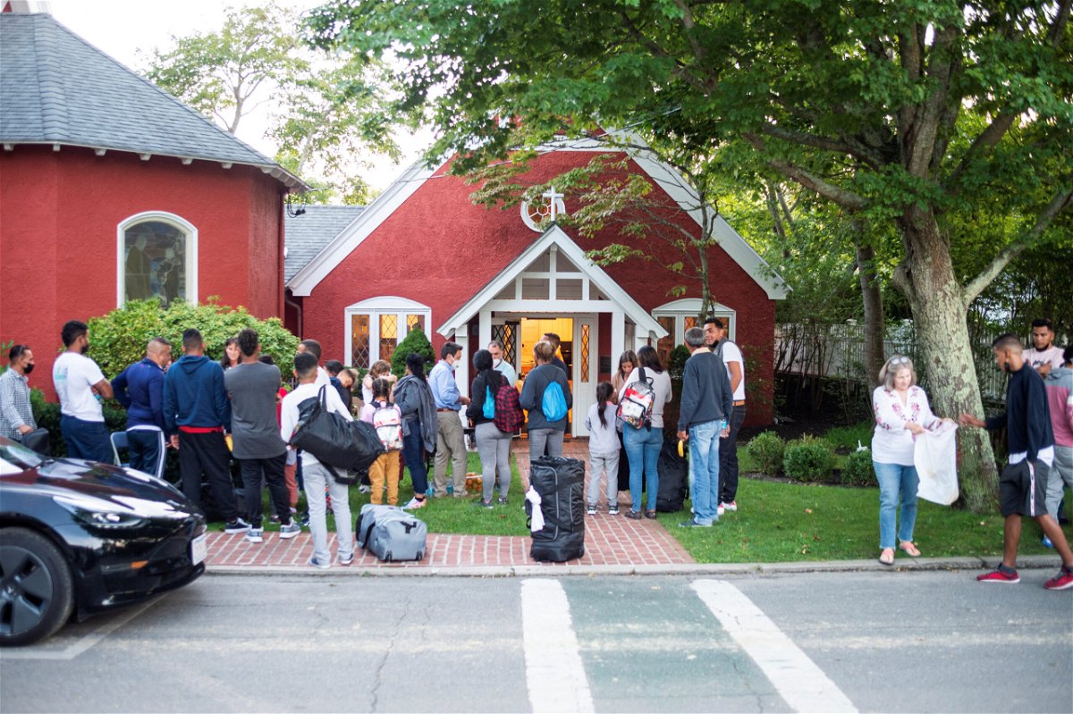 <i>Ray Ewing/Vineyard Gazette/Reuters</i><br/>Venezuelan migrants stand outside St. Andrew's Church in Edgartown