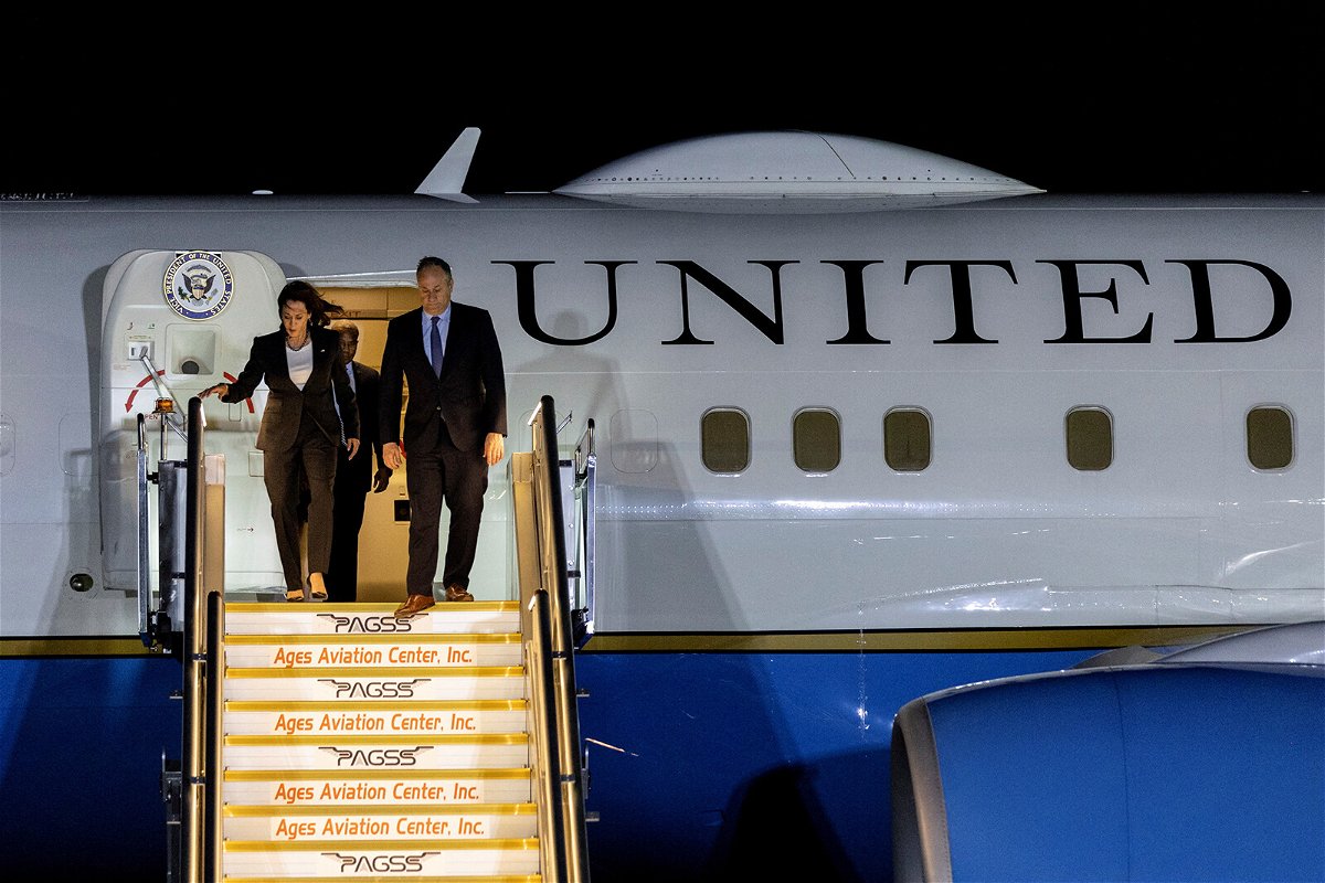<i>Eloisa Lopez/Reuters</i><br/>Vice President Kamala Harris and her husband Doug Emhoff arrive at Ninoy Aquino International Airport