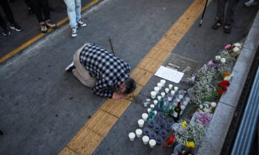 A mourner pays tribute at a makeshift memorial near the site of the crush in Seoul on October 30.