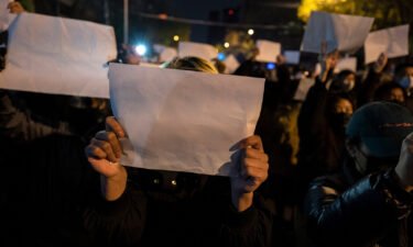 Protesters hold up a white piece of paper against censorship as they march during a protest against China's strict Covid-19 measures on November 27