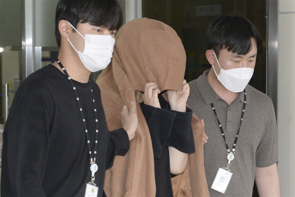 <i>Bae Byung-soo/Newsis/AP</i><br/>The mother appears in a New Zealand court over the alleged suitcase murders. She's seen here leaving a police station in Ulsan