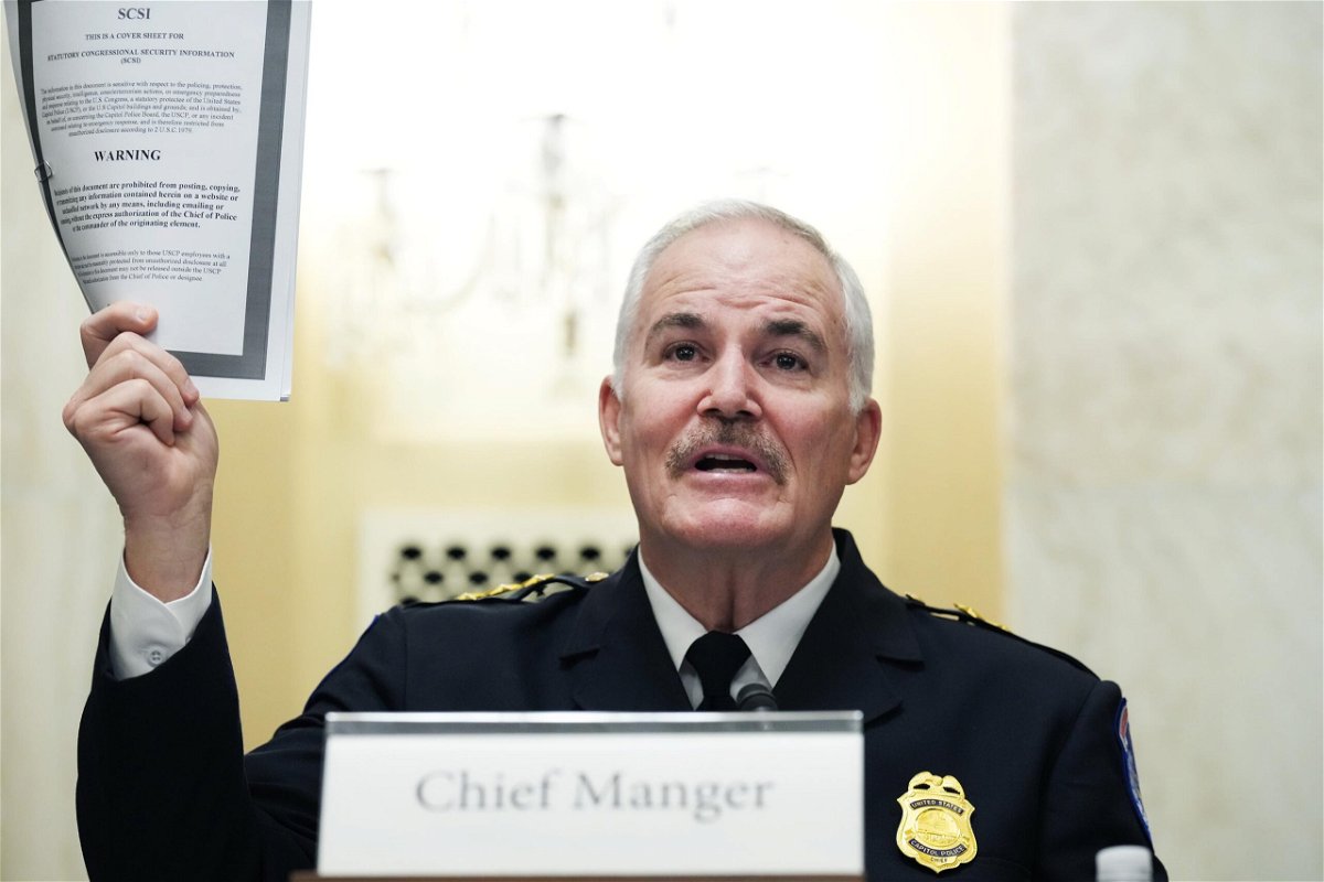 <i>Tom Williams-Pool/Getty Images</i><br/>U.S. Capitol Police Chief J. Thomas Manger holds up a statutory congressional security information report while testifying during the Senate Rules and Administration Committee oversight hearing on January 5