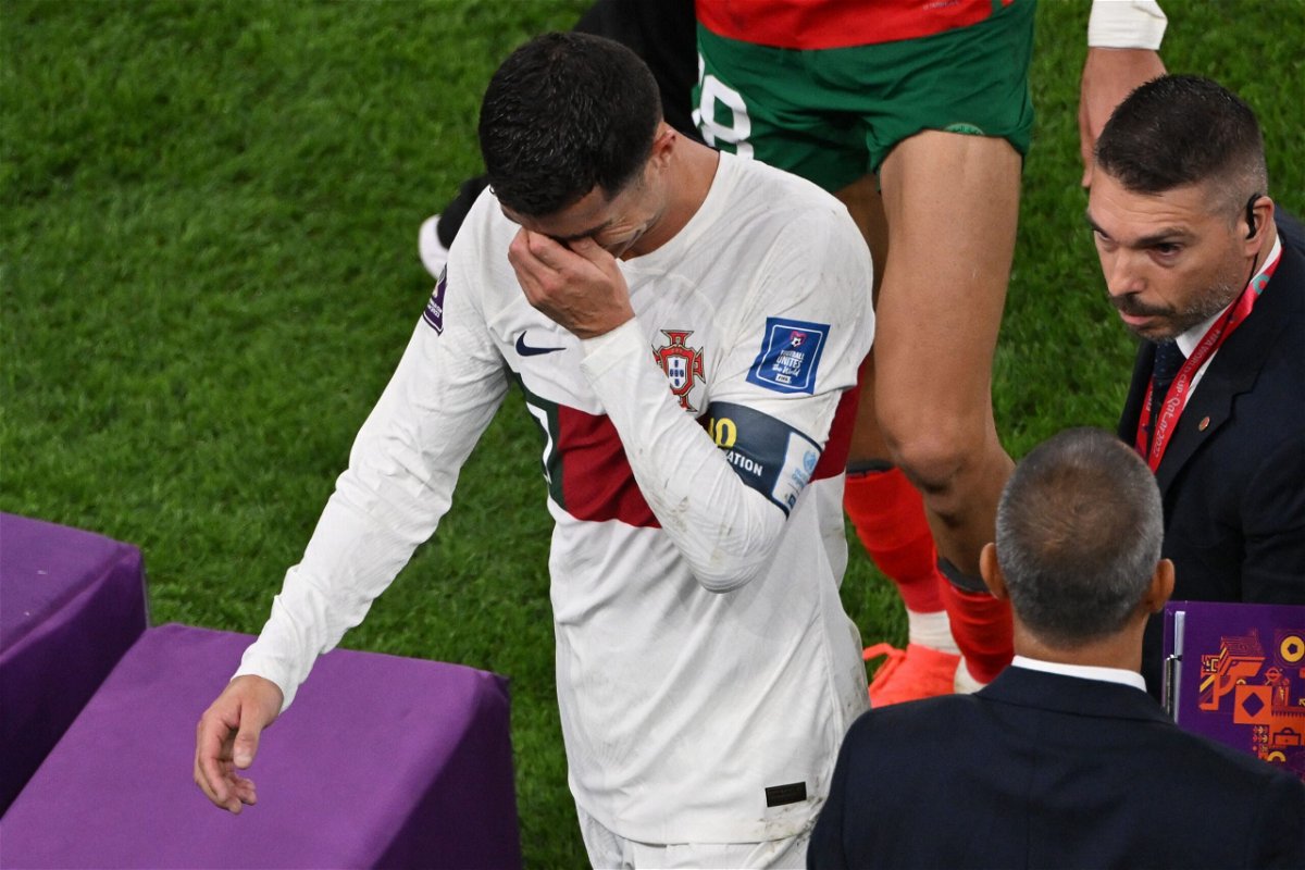 <i>NELSON ALMEIDA/AFP/AFP via Getty Images</i><br/>Cristiano Ronaldo leaves the pitch in tears after Portugal lost 1-0 to Morocco.