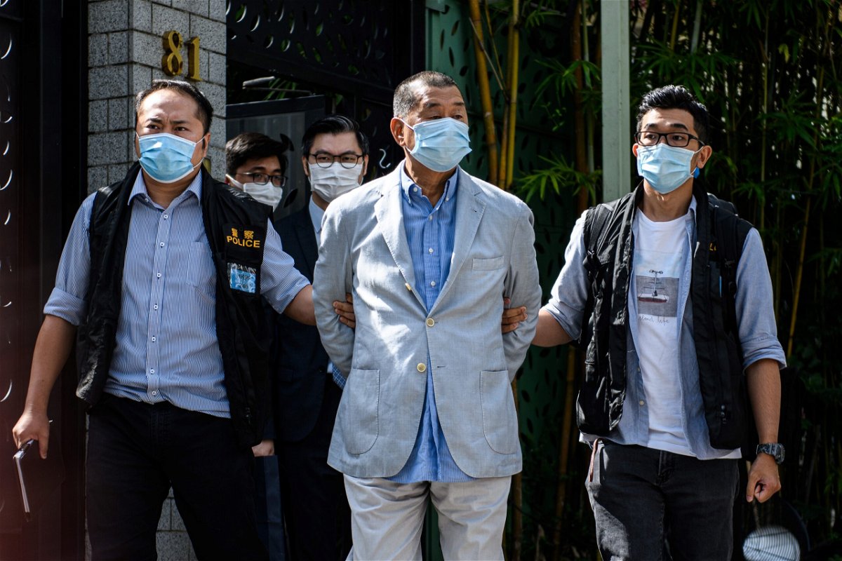 <i>VERNON YUEN/AFP/AFP via Getty Images</i><br/>Police lead Hong kong pro-democracy media mogul Jimmy Lai away from his home after he was arrested under the new national security law in Hong kong on August 10