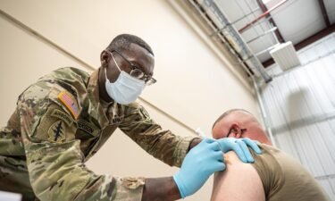 Sergeant First Class Demetrius Roberson administers a Covid-19 vaccine to a soldier on September 9