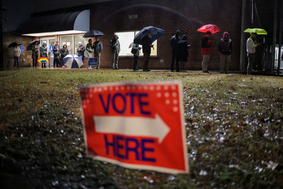 <i>Carlos Barria/Reuters</i><br/>Local residents wait in line to cast their ballot during the runoff U.S. Senate election between Democratic Senator Raphael Warnock and his Republican challenger Herschel Walker in Atlanta