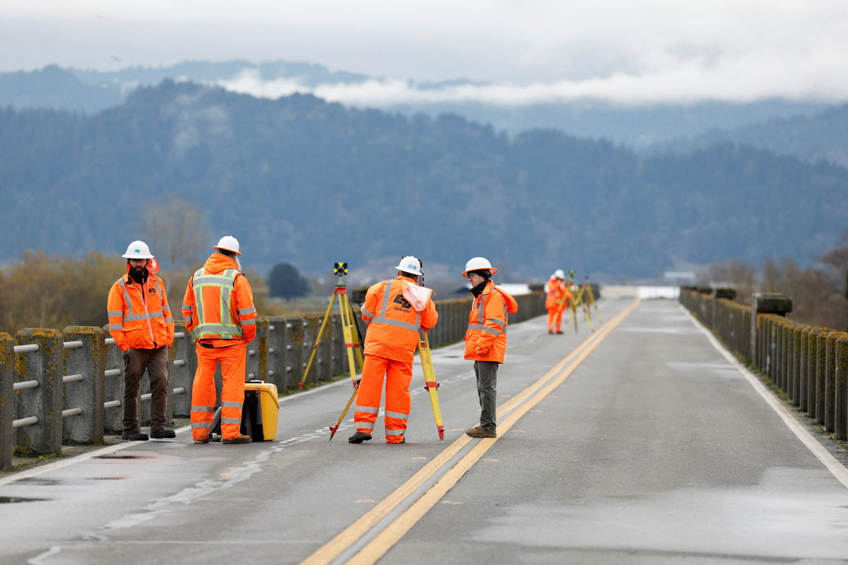 <i>Fred Greaves/Reuters</i><br/>Thousands are still without power after a California earthquake. Transportation workers are seen here assessing damage to a bridge after the earthquake.