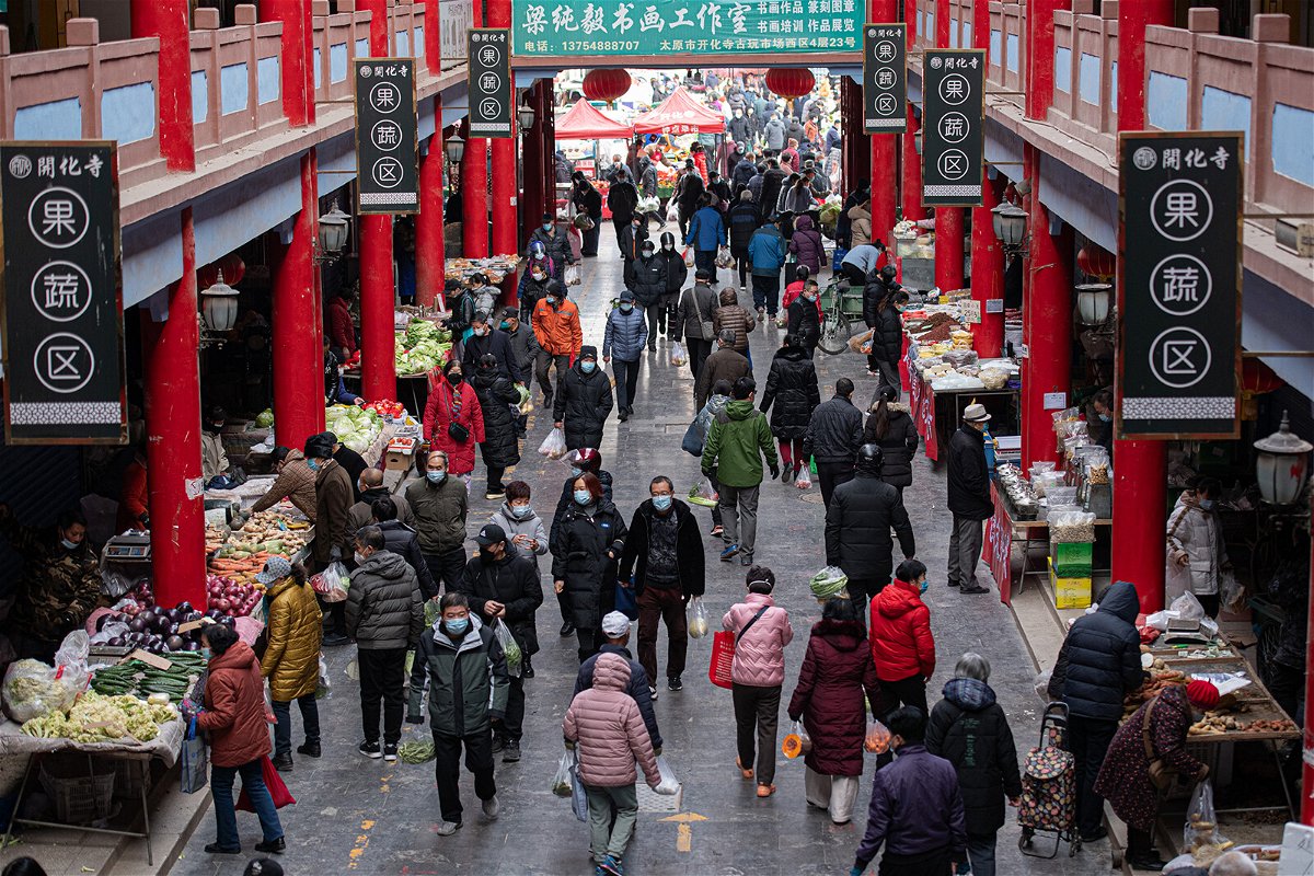 <i>Wei Liang/China News Service/Getty Images</i><br/>Residents shop for vegetables at a wet market in Taiyuan