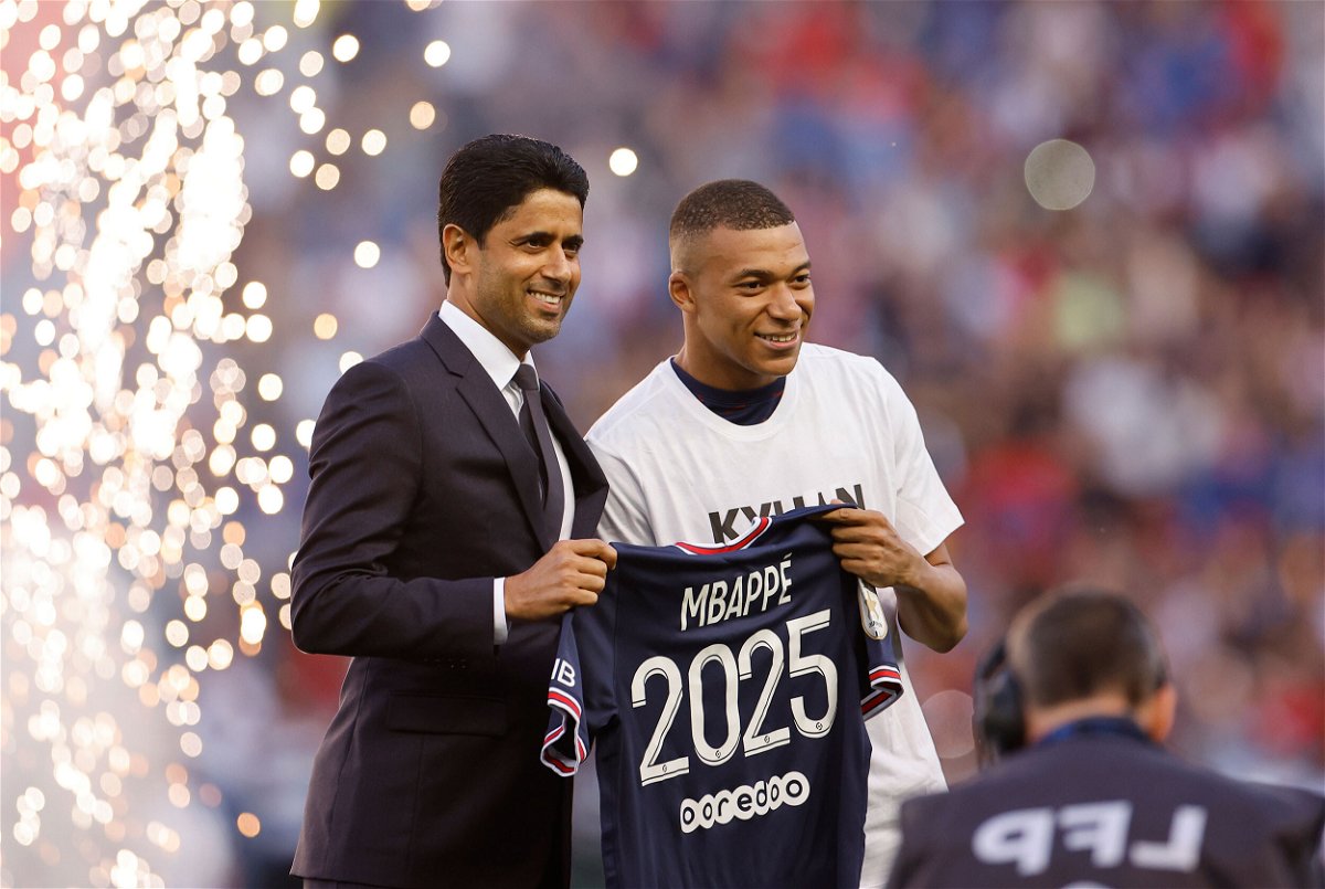 <i>Christian Hartmann/Reuters</i><br/>Paris St. Germain's Kylian Mbappe (right) poses for a photo with Paris St. Germain president Nasser Al-Khelaifi after signing a new contract on May 21.