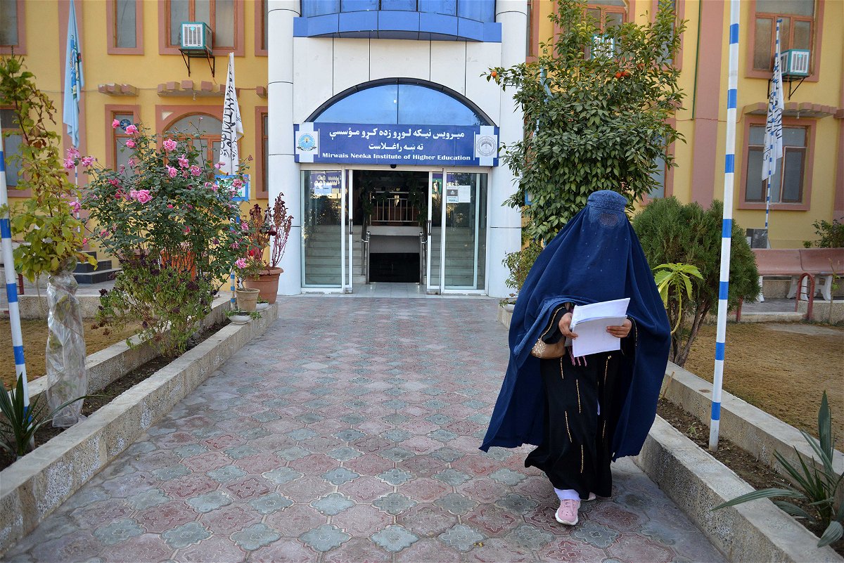 <i>Stringer/AFP/Getty Images</i><br/>A female student walks in front of a university in Kandahar province