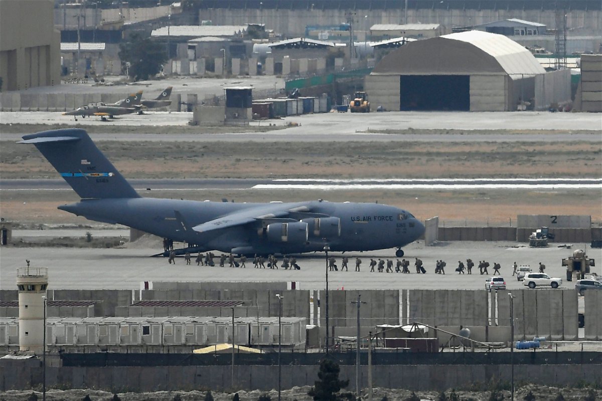 <i>Aamir Qureshi/AFP/Getty Images</i><br/>US soldiers board a US Air Force aircraft at the airport in Kabul in August 2021. The Afghan Adjustment Act will not be included in the omnibus spending bill.