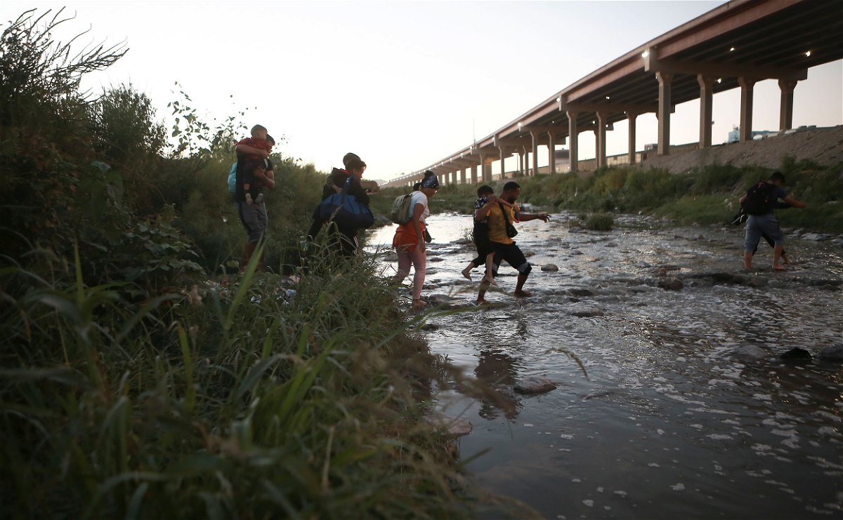 <i>Christian Chavez/AP</i><br/>The Biden administration is considering a proposal that would bar migrants from seeking asylum at the US-Mexico border if they could have received refuge in another country. Venezuelan migrants are pictured walking across the Rio Bravo on October 13.