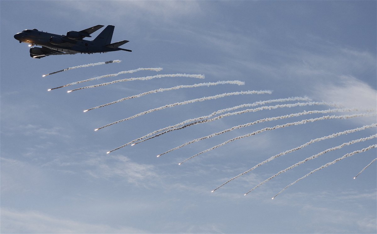 <i>Issei Katto/Pool/Getty Images</i><br/>A Japan Maritime Self-Defence Force Kawasaki P-1 patrol aircraft fires flares during an International Fleet Review commemorating the 70th anniversary of the founding of the Japan Maritime Self-Defense Force at Sagami Bay on November 6 off Yokosuka