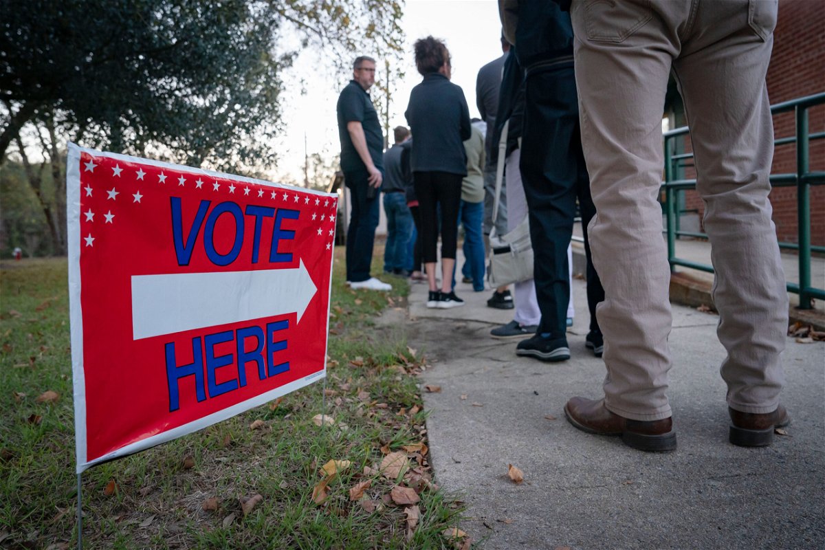 <i>Allison Joyce/Getty Images</i><br/>People wait in line to vote at a polling place in Fuquay-Varina