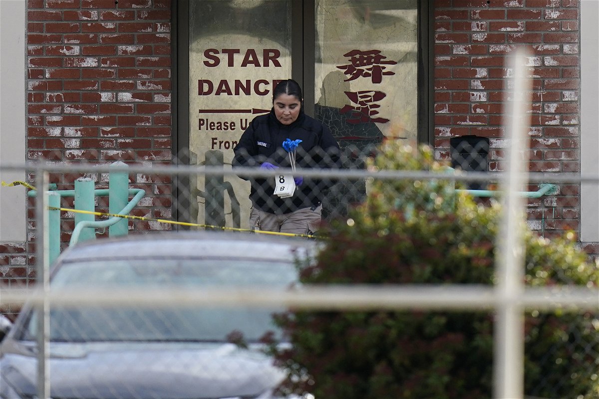 <i>Jae C. Hong/AP</i><br/>An investigator carries markers outside Star Dance Studio in Monterey Park