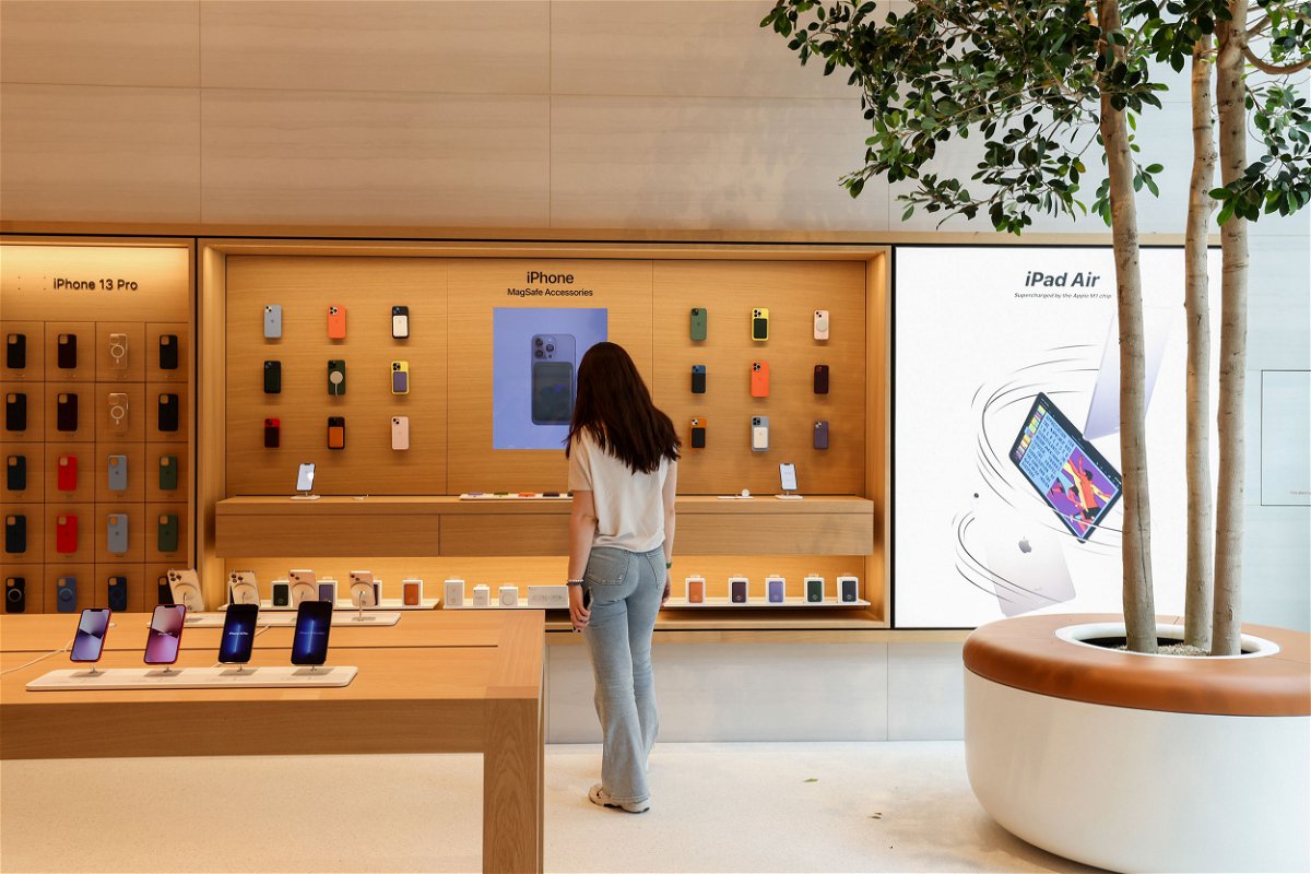 <i>Hollie Adams/Bloomberg/Getty Images</i><br/>Apple has lost $1 trillion in market value in a year. A visitor browses an iPhone display at a new Apple store.