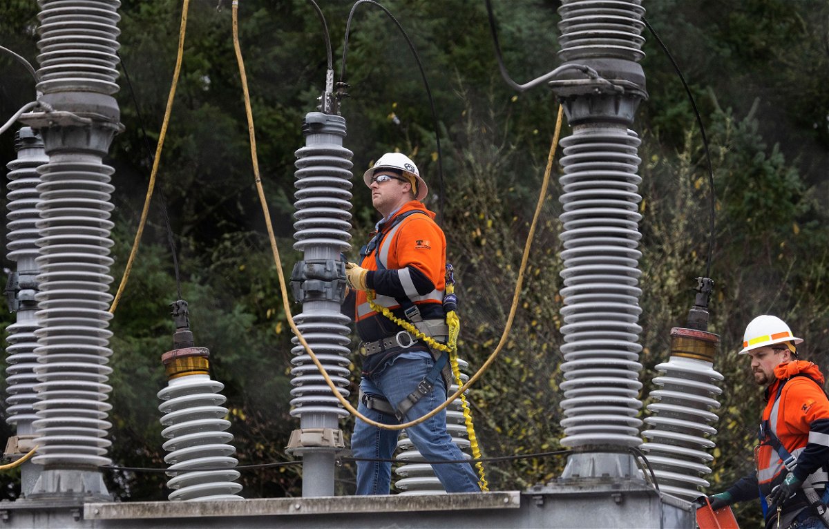 <i>Ken Lambert/The Seattle Times/AP</i><br/>A Tacoma Power crew works at an electrical substation damaged by vandals on December 25